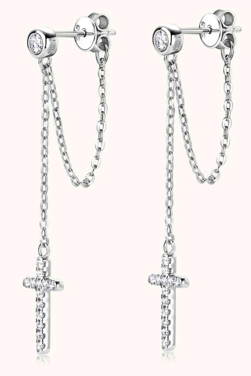 a pair of cross and chain earrings