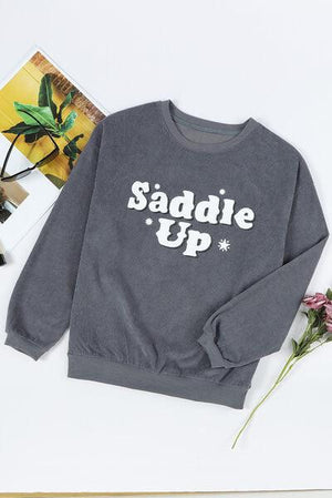 a sweatshirt with the words saddle up printed on it