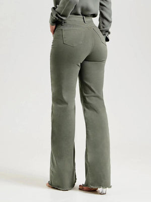 a woman in a gray shirt and green pants