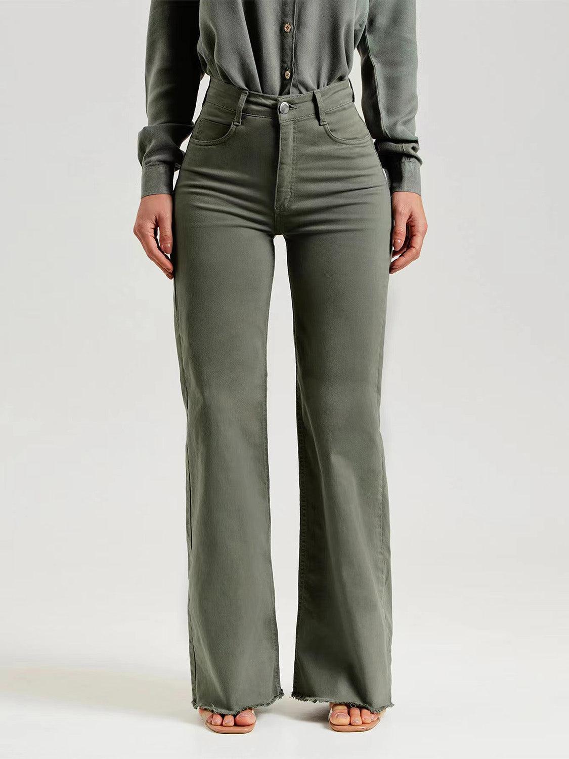 a woman in a gray shirt and green pants