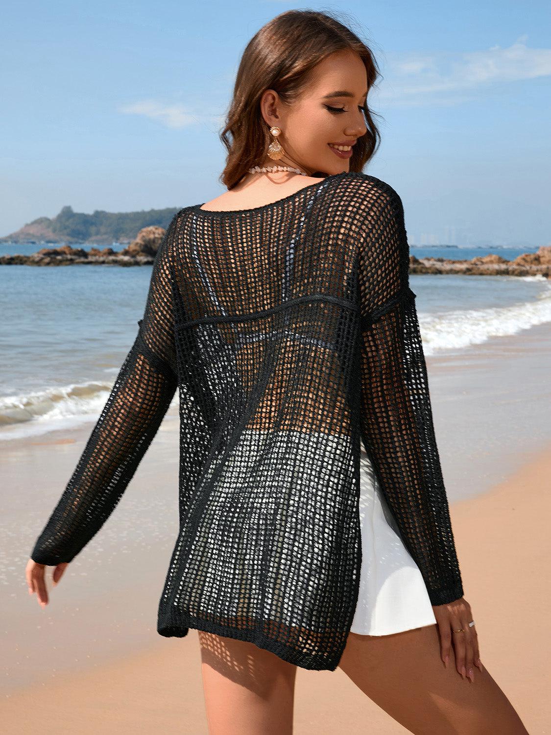 a woman standing on a beach next to the ocean