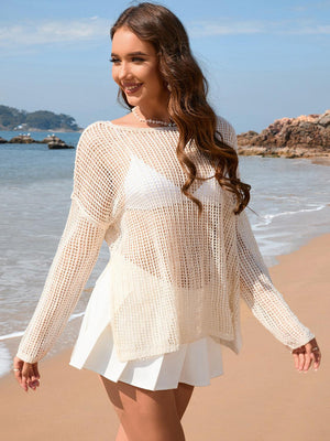 a woman walking along a beach next to the ocean