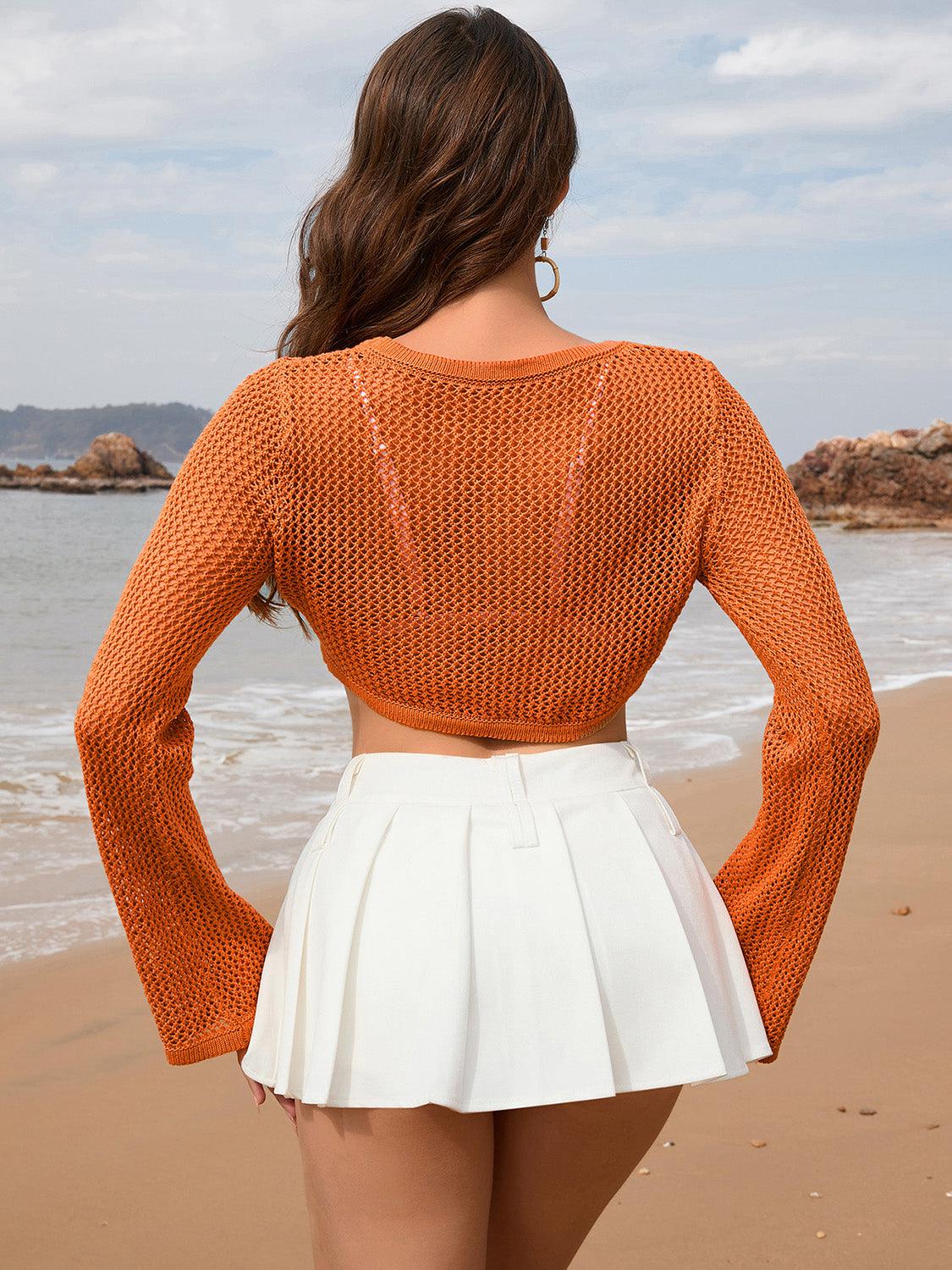 a woman standing on a beach next to the ocean