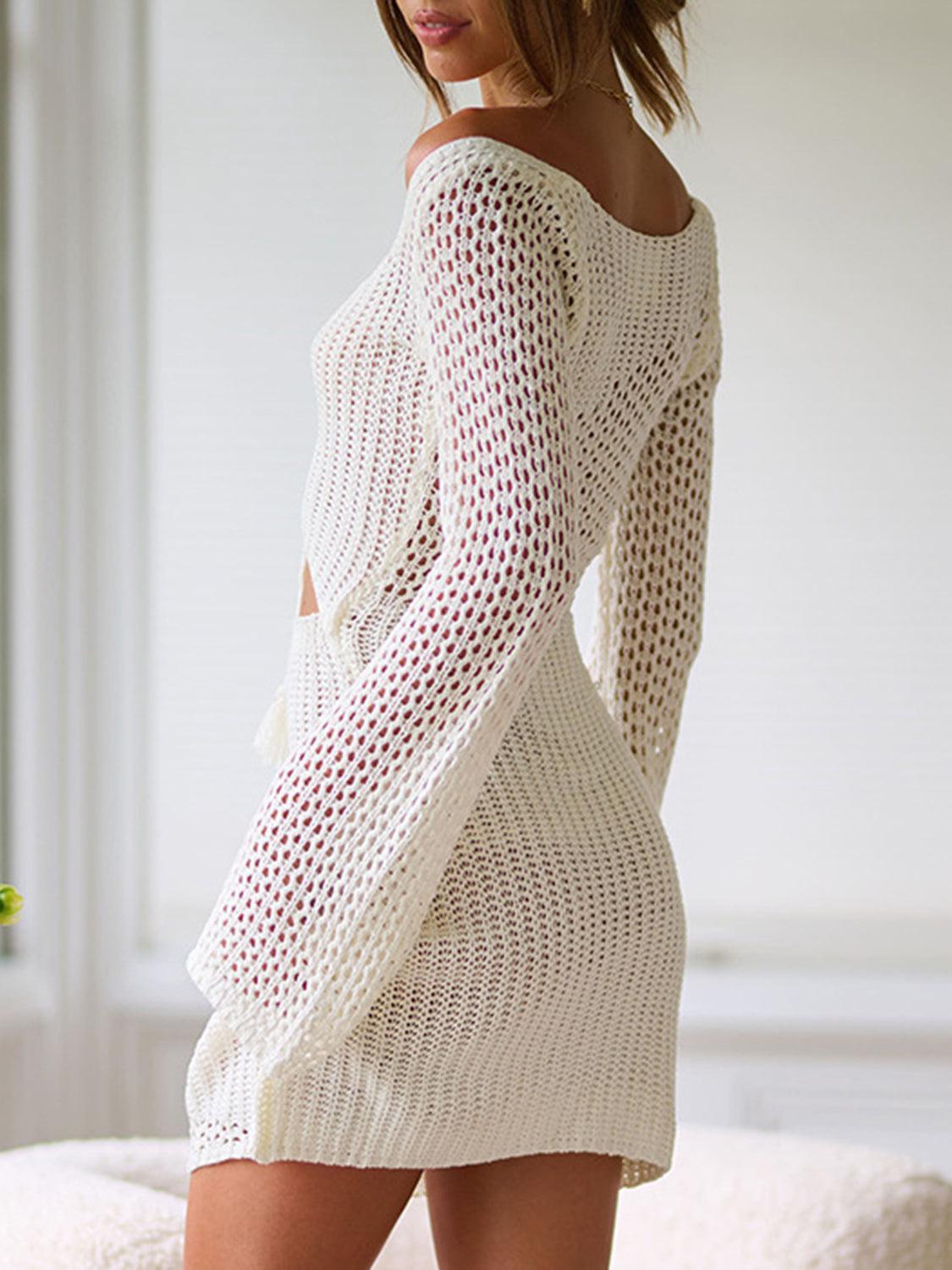 a woman in a white sweater dress posing for a picture