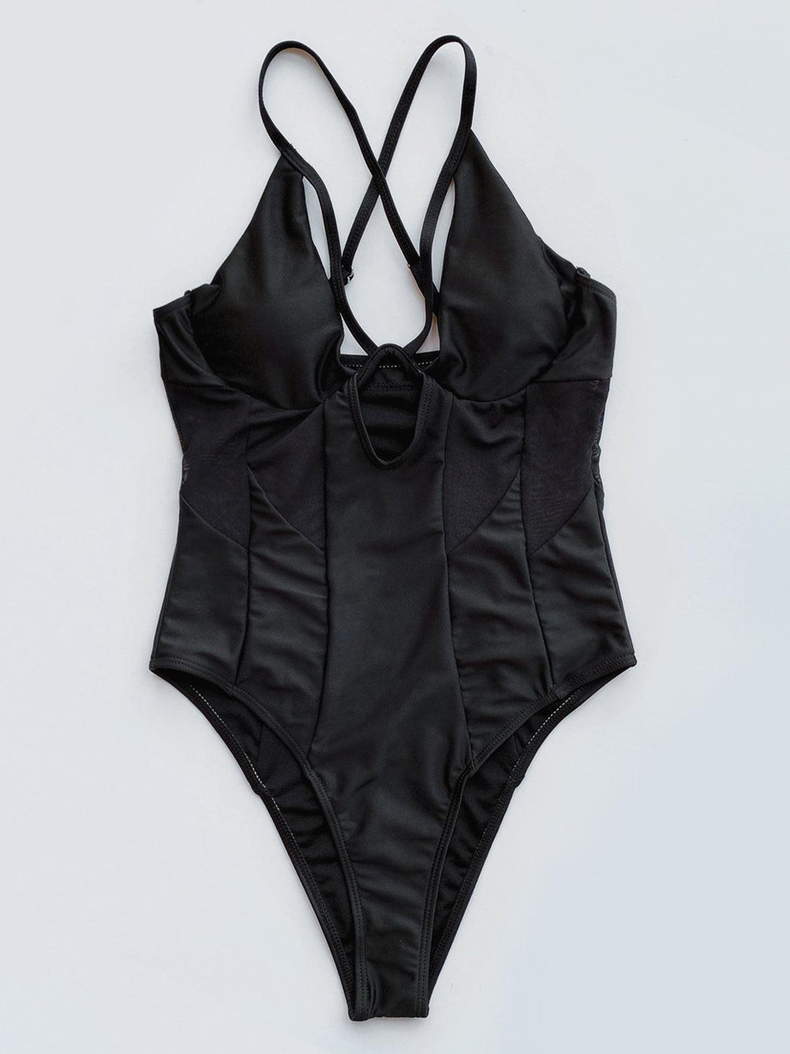 a black one piece swimsuit on a white background