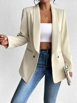 a woman in a white top and a beige blazer