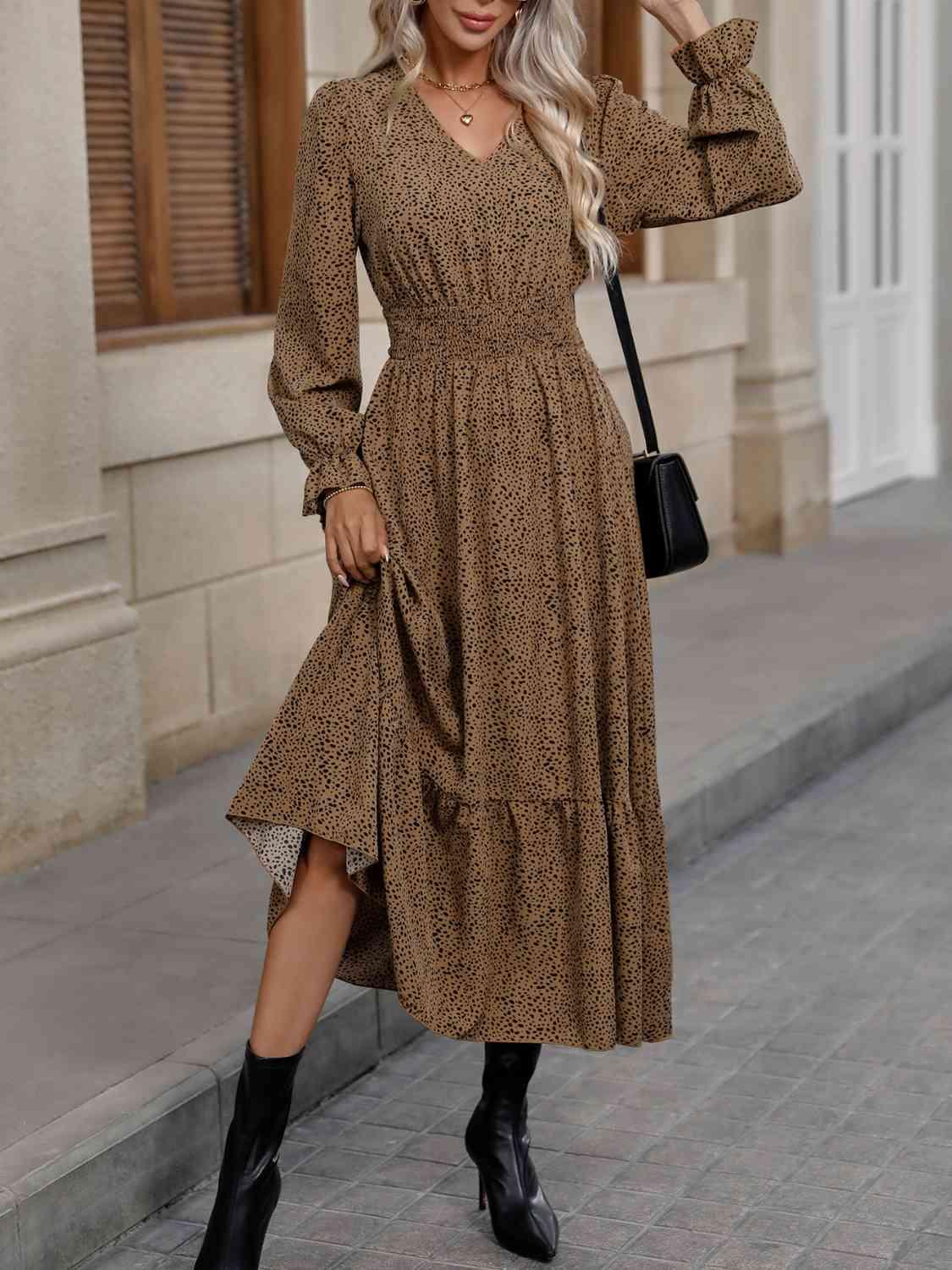 a woman wearing a brown dress and black boots
