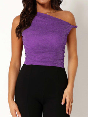 a woman wearing a purple top and black pants