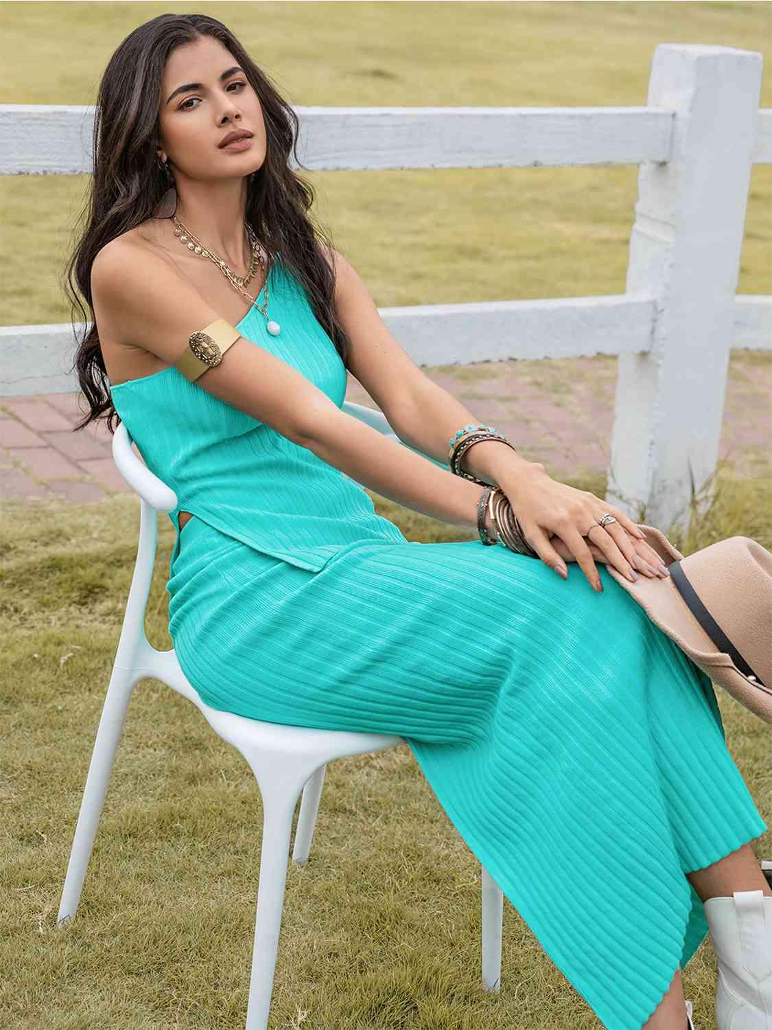 a woman sitting on a chair in a blue dress