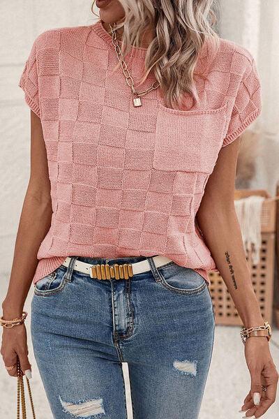 a woman wearing a pink top and ripped jeans