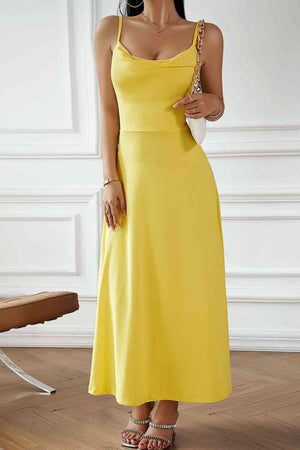 a woman in a yellow dress posing for a picture