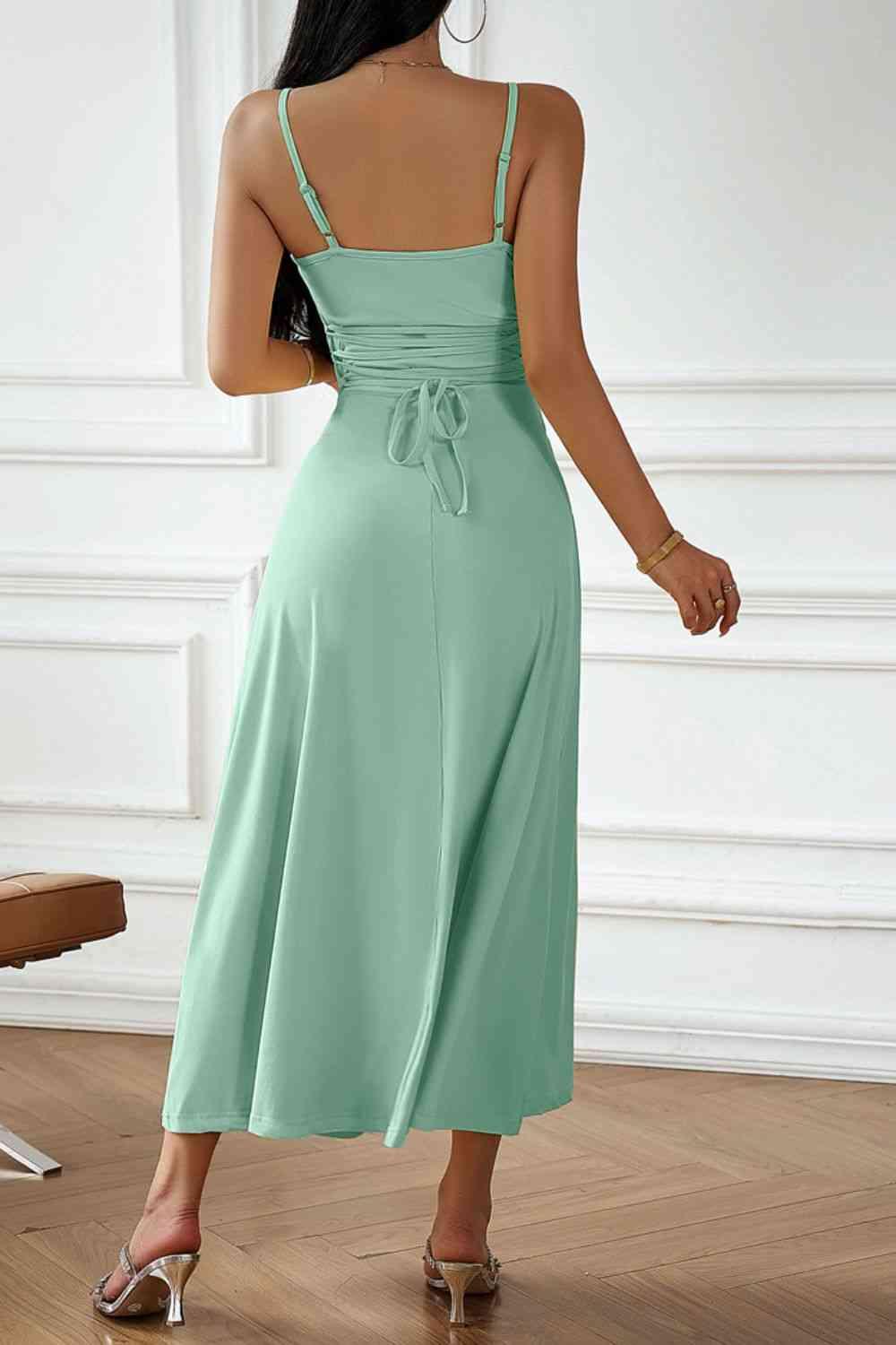 the back of a woman wearing a green dress