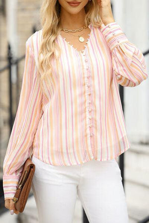 a woman in white pants and a striped shirt