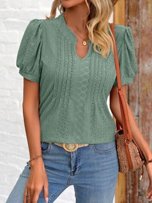 a woman wearing a green top and jeans