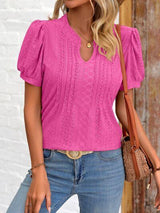 a woman wearing a pink top and jeans