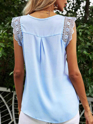 a woman wearing a light blue top with lace detailing