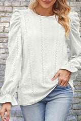 a woman wearing a white sweater and jeans