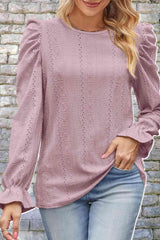 a woman wearing a pink sweater and jeans