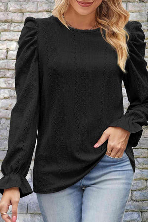 a woman wearing a black top and jeans