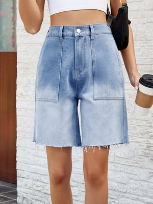 a woman holding a cup of coffee and a cell phone