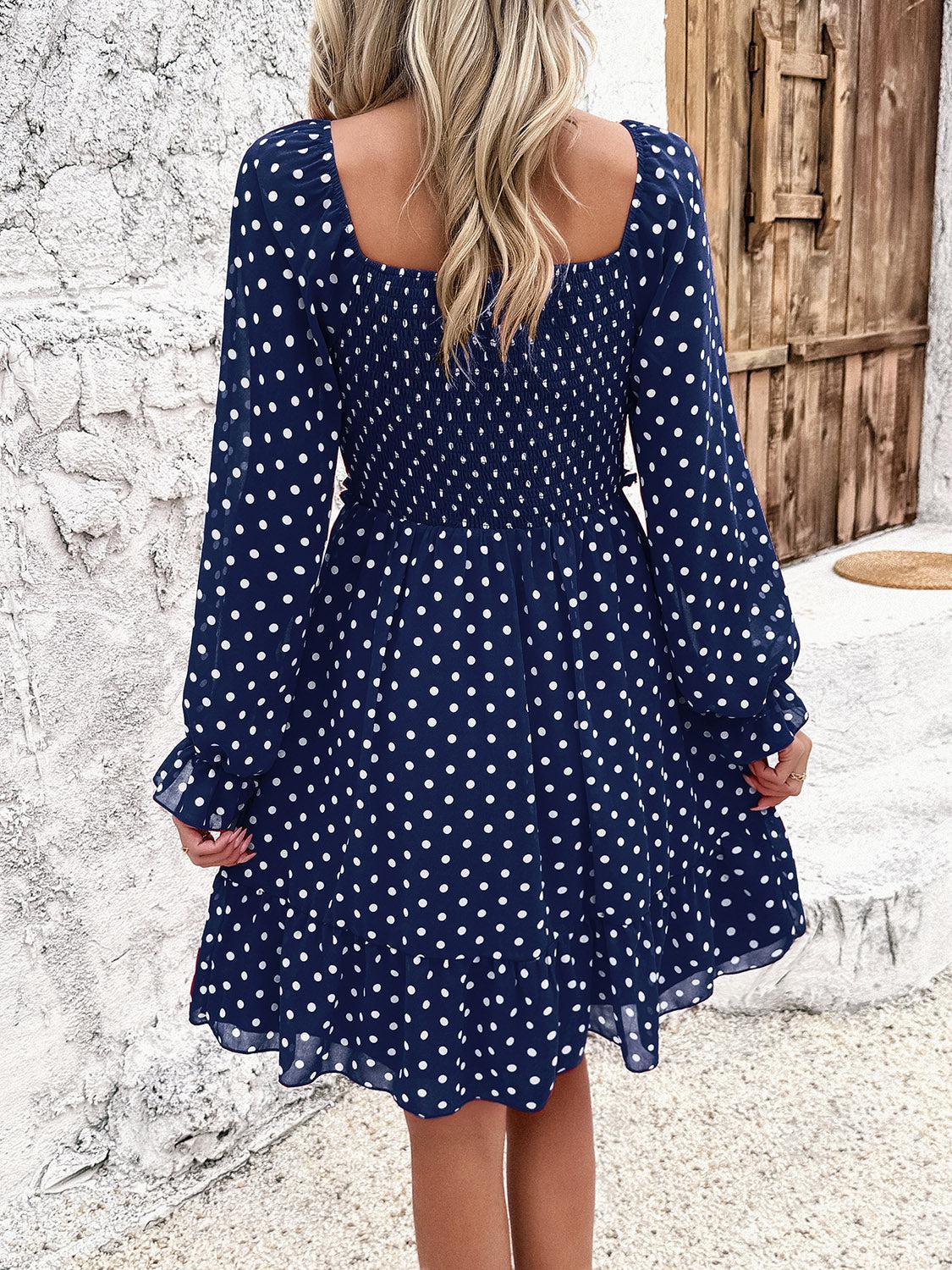 a woman wearing a blue polka dot dress