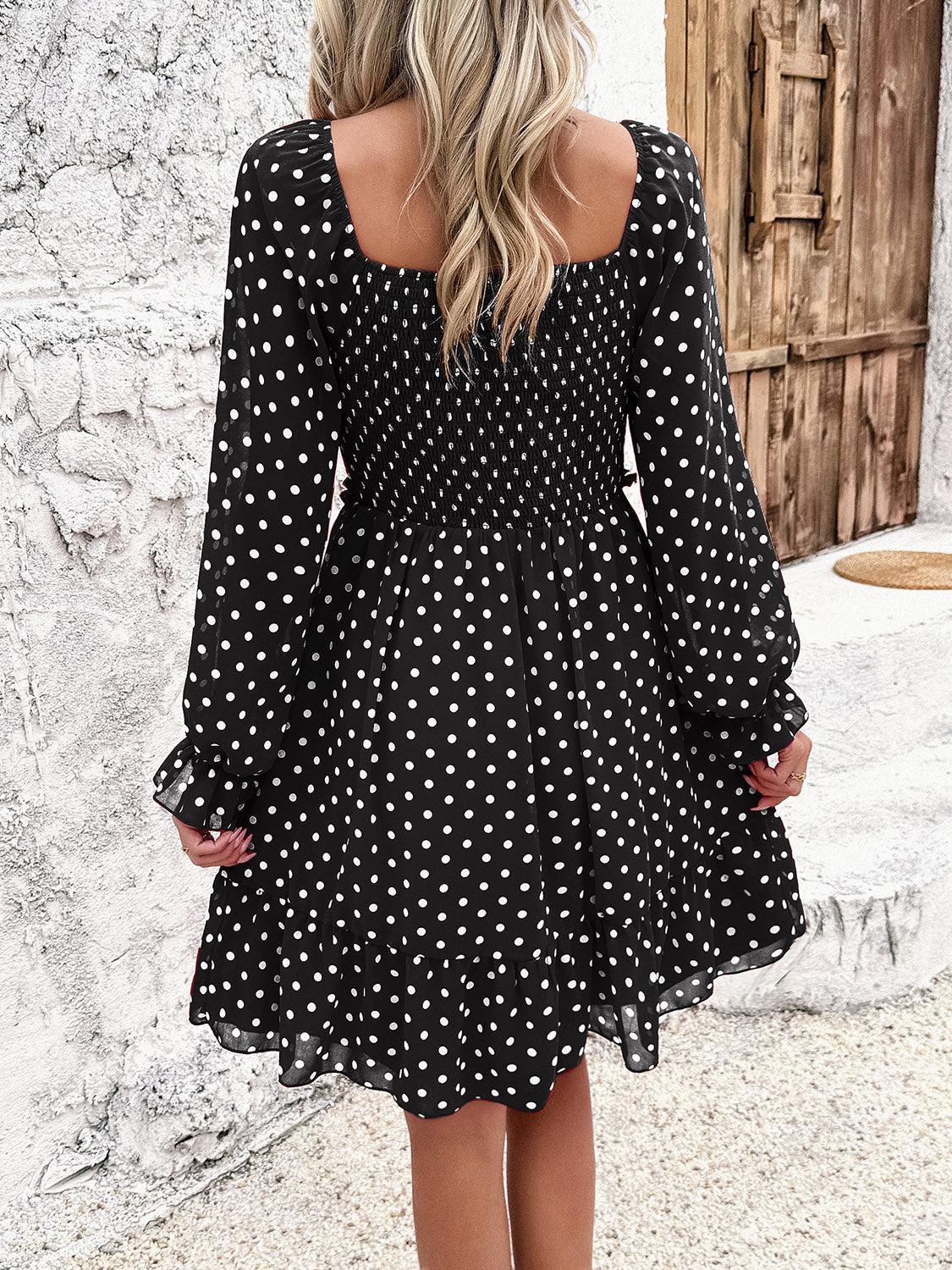 a woman wearing a black and white polka dot dress