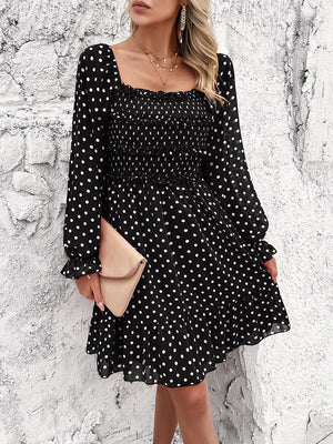 a woman wearing a black and white polka dot dress