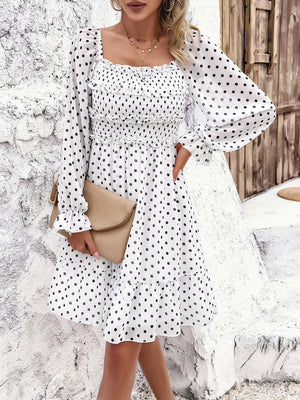a woman wearing a white polka dot dress