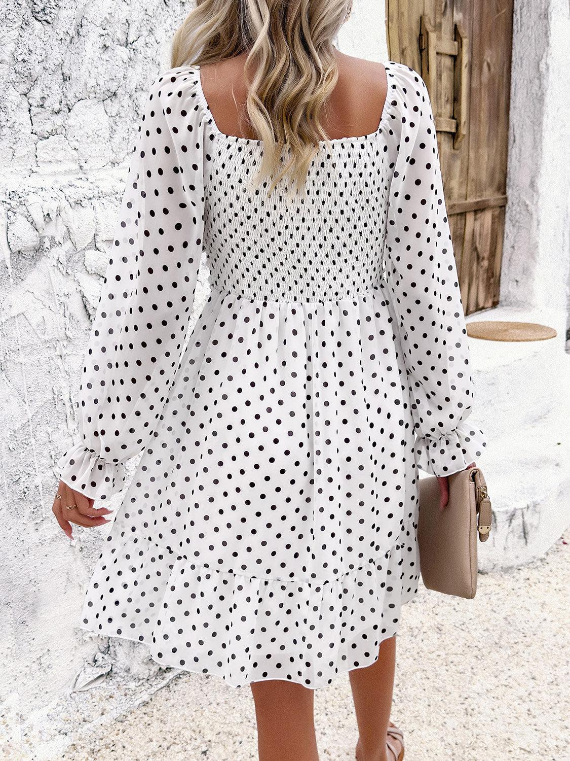a woman in a white polka dot dress