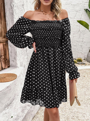 a woman wearing a black and white polka dot dress