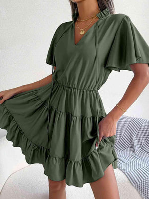 a woman in a green dress posing for the camera