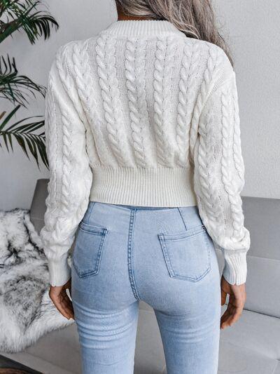 a woman wearing a white sweater and jeans