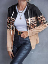 a woman posing for a picture wearing a leopard print jacket