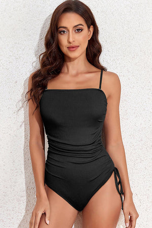 a woman in a black one piece swimsuit