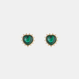 a pair of earrings with green stones