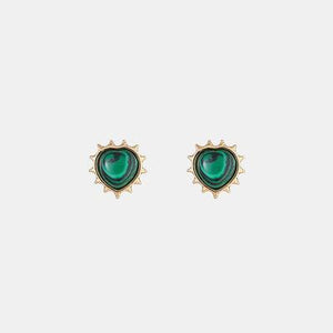 a pair of earrings with green stones