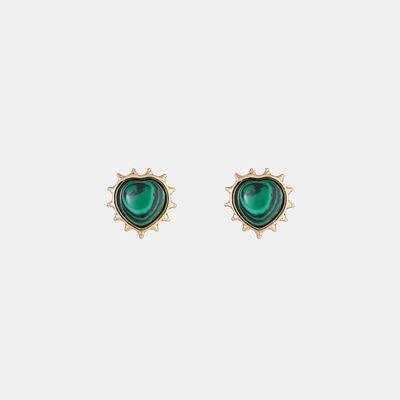 a pair of earrings with green stones