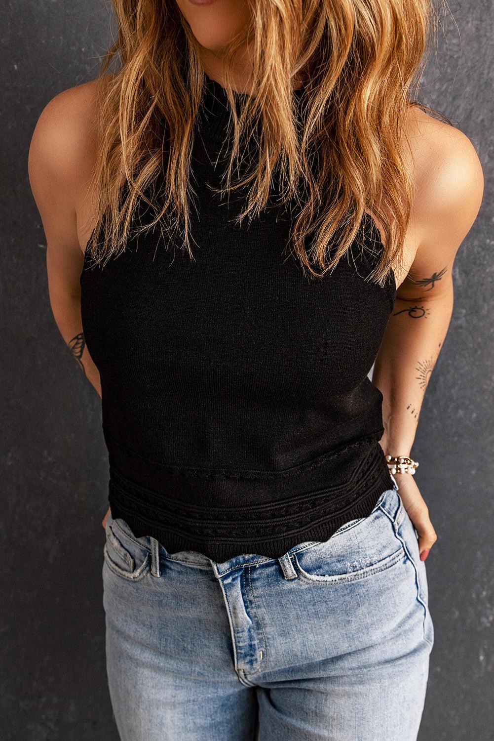 a woman wearing a black top and jeans