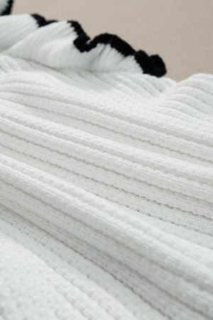 a close up of a white blanket on a bed