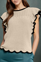 a woman wearing a sweater with ruffles on it