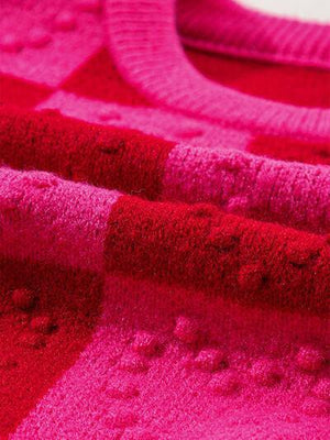 a close up of a pink and red blanket