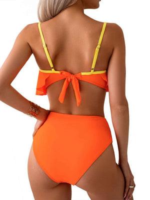 a woman in an orange bikini top and bottom