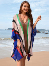 a beautiful woman standing on top of a sandy beach