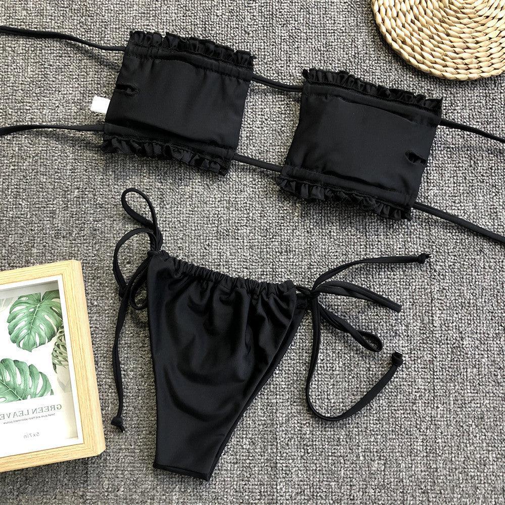 a pair of black bikinis sitting on top of a carpet