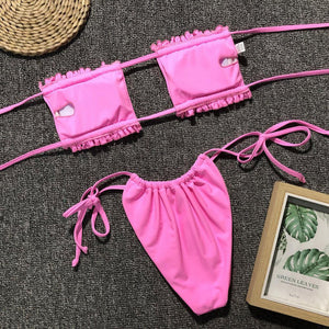 a woman's pink bikini top and matching panties