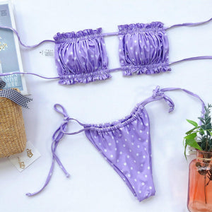 a purple bikini with white polka dots on it