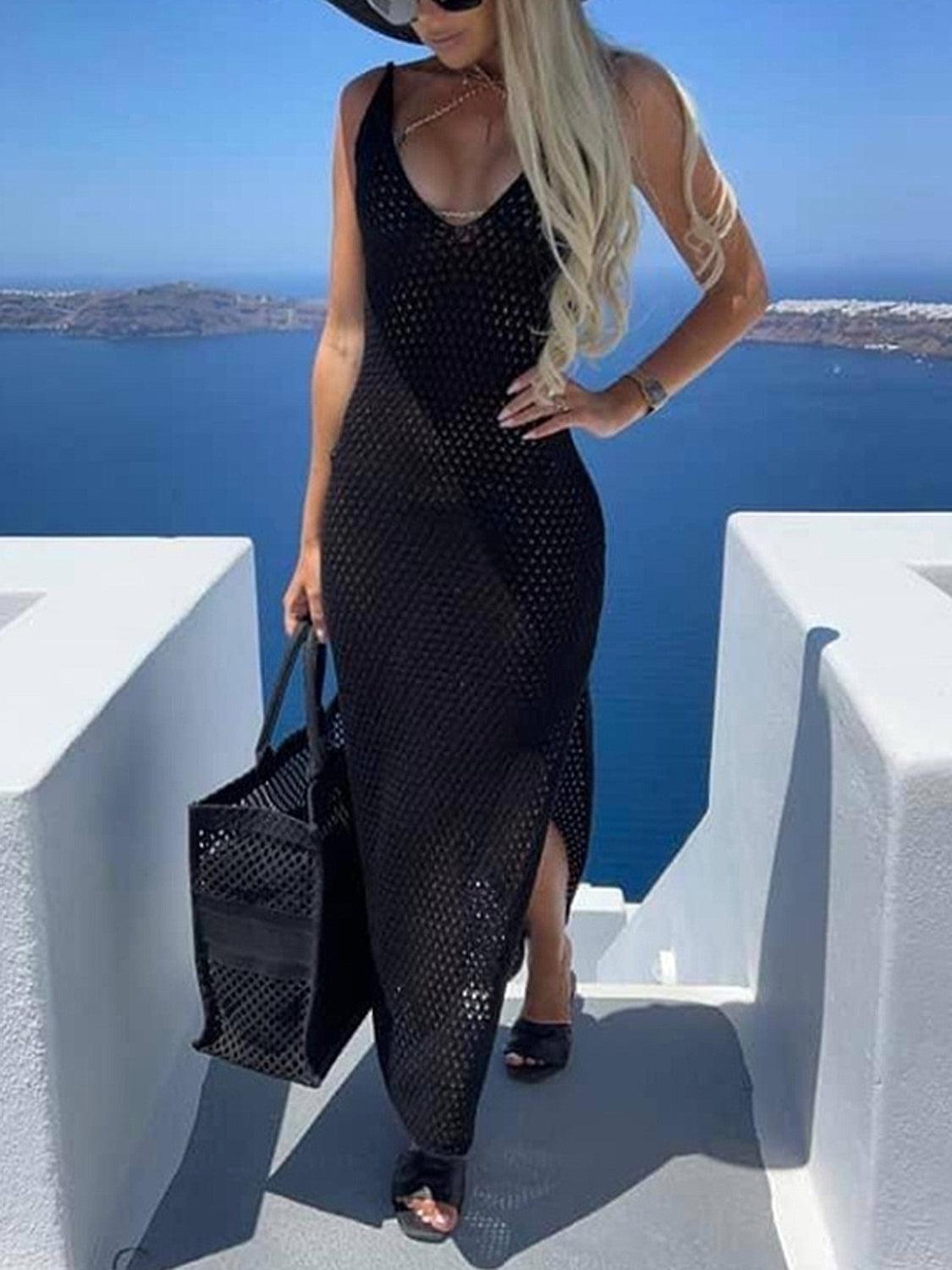 a woman in a black dress is standing on a ledge