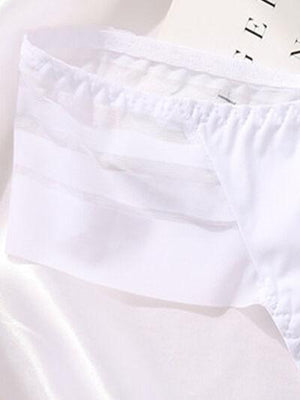 a pair of white underwear sitting on top of a bed