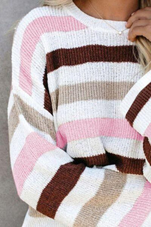 a woman wearing a pink and brown striped sweater