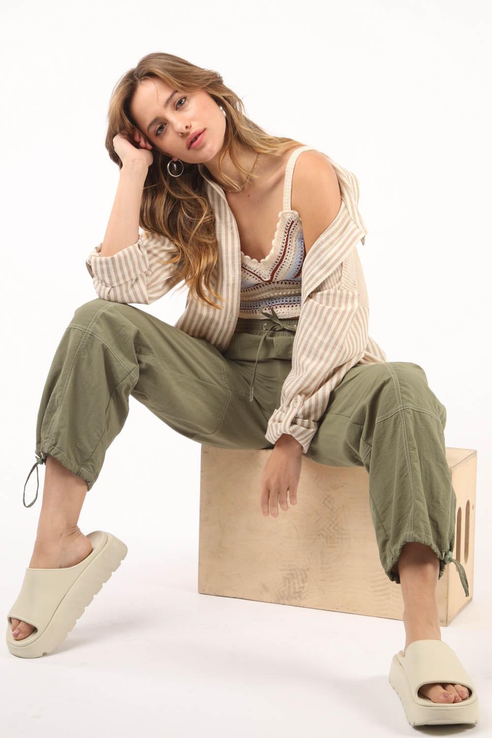 a woman sitting on top of a wooden box